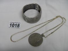 A Theresa silver coin pendant and an ornate silver pendant (tested)