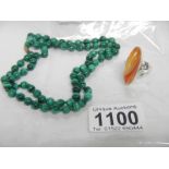 A vintage malachite necklace and an amber ring set in silver