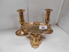 A solid brass dish surmounted by mermaid & a pair of brass candlesticks