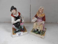 A pair of Staffordshire figures,