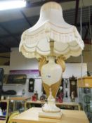 An ornate Adam style table lamp