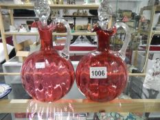 A pair of Victorian cranberry glass decanters