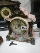 A Victorian porcelain mantel clock with cloissonne pillars