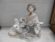 A large Nao Geisha girl playing a stringed instrument A/F