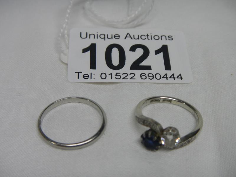 An 18ct white gold diamond and sapphire engagement ring and an 18ct gold wedding ring,