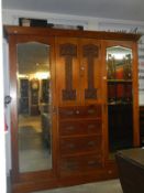 A superb Victorian compactum wardrobe with art nouveau carvings to doors