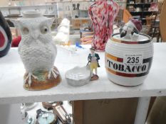 A 19th century Continental porcelain owl oil lamp & tobacco jar (both A/F) & a pipe stand