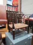 A 19th century child's carver chair with string seat