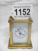 A small brass carriage clock by Mignon