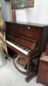A Barratt & Robinson upright mahogany piano