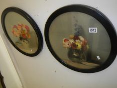 A pair of oils on board in round frames