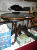 A small Victorian oval black table