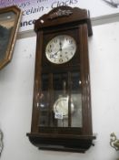 A 1930's wall clock with 3 bevelled glass panels