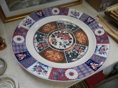 A large Chinese plate/charger featuring flower design with roses