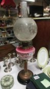 An antique cranberry milk glass double burner oil lamp & shade