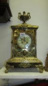 Ornate brass mantle clock with dragon urn top and lion masks to sides