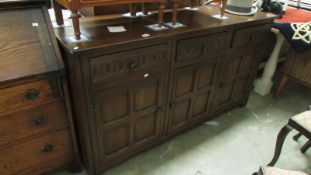 An oak linen fold side cabinet