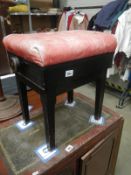 A 1930's leather topped adjustable piano stool