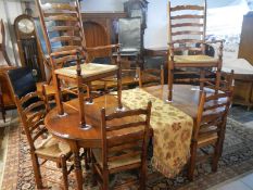 A large oak dining table & set of 8 ladder back chairs