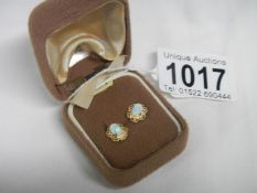 A pair of 9ct gold and opal earrings