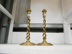 A pair of brass spiral candlesticks drilled for electric