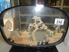 A fine Oriental carving under glass,