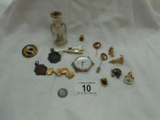 A quantity of miscellaneous badges, watch fobs, cufflink's, coins,