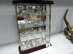 A quantity of crystal miniatures in a cabinet