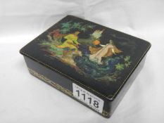 A Russian black lacquered box decorated with a fairy tale scene,