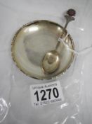 A silver pin dish with decoration and a silver collector's spoon featuring rose