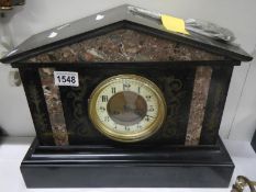 A black slate mantel clock with marble inlay