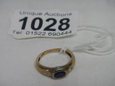 A diamond and sapphire yellow gold ring