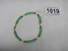 An Oriental silver gilt and jade bracelet