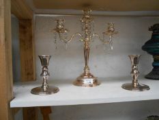 A silver plated candelabara with droppers & a pair of candlesticks