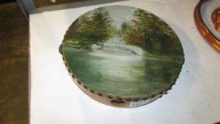 A Victorian tambourine with oil painting of lake, bridge,