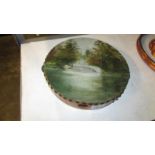 A Victorian tambourine with oil painting of lake, bridge,