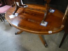 Oval dark wood stained coffee table with brass lion paw feet