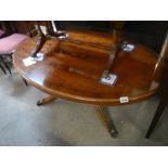 Oval dark wood stained coffee table with brass lion paw feet