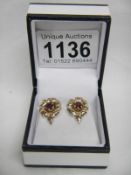 A pair of 9ct rose gold earrings set rubies