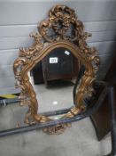 A mirror in ornamental plaster frame