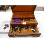 A wooden jewellery box with a quantity of costume jewellery