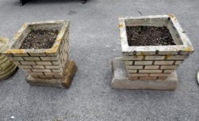 A pair of square concrete planters