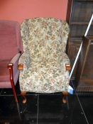 A floral patterned wingback armchair