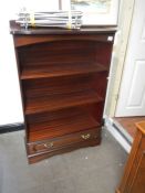 A mahogany bookcase with drawer