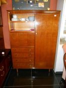 A wardrobe with drawers and pull down cupboard