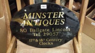 An old glass Minster Antiques sign