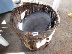 A wicker basket and tin bucket