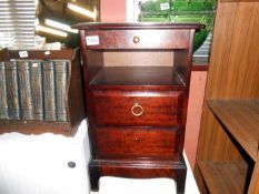 A mahogany bedside cabinet