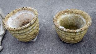 A pair of round concrete planters