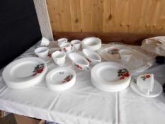 A quantity of cups and plates with rose design